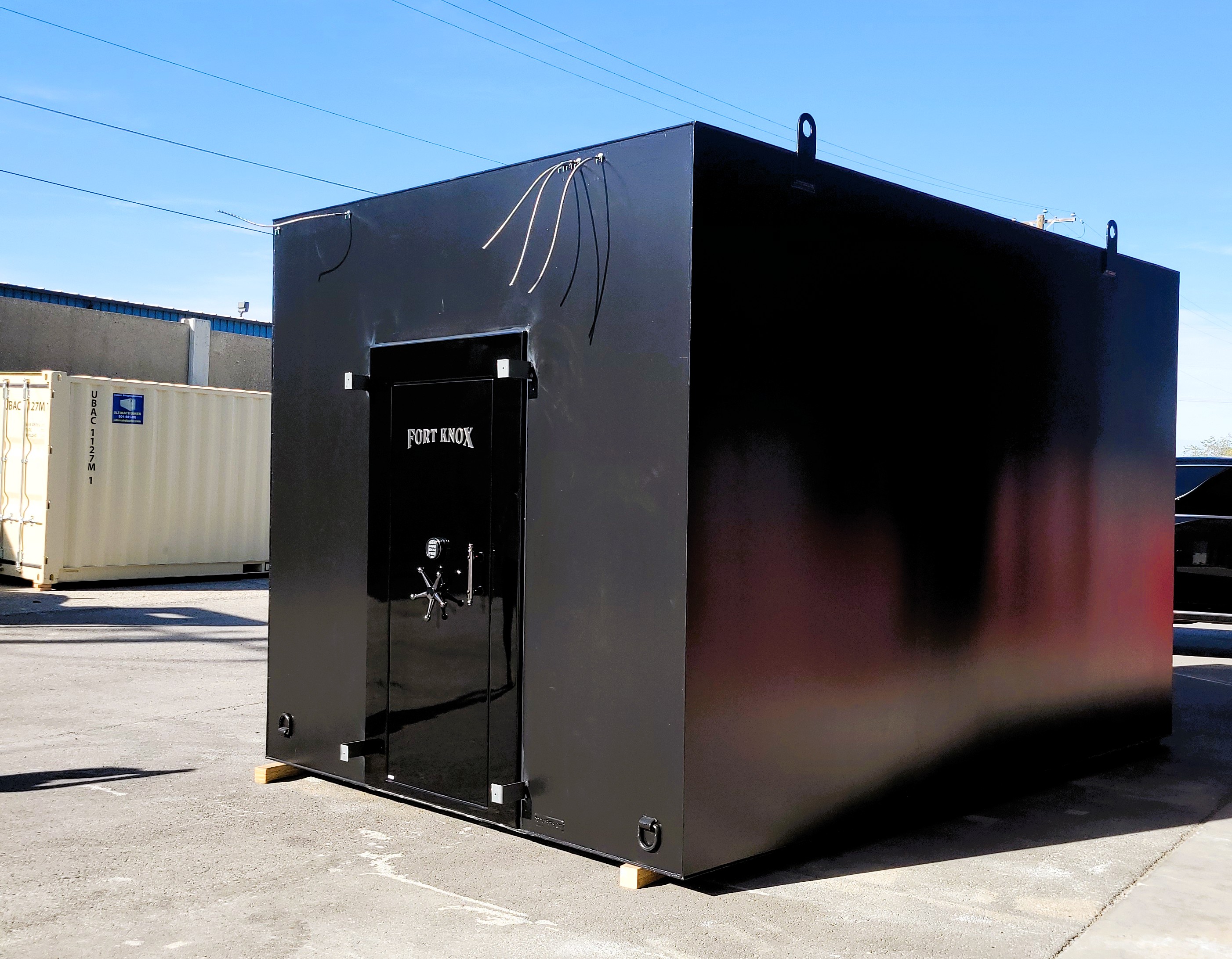 10 x 15 walk in gun vault featuring a gloss black Fort Knox vault door by Ultimate Bunker
